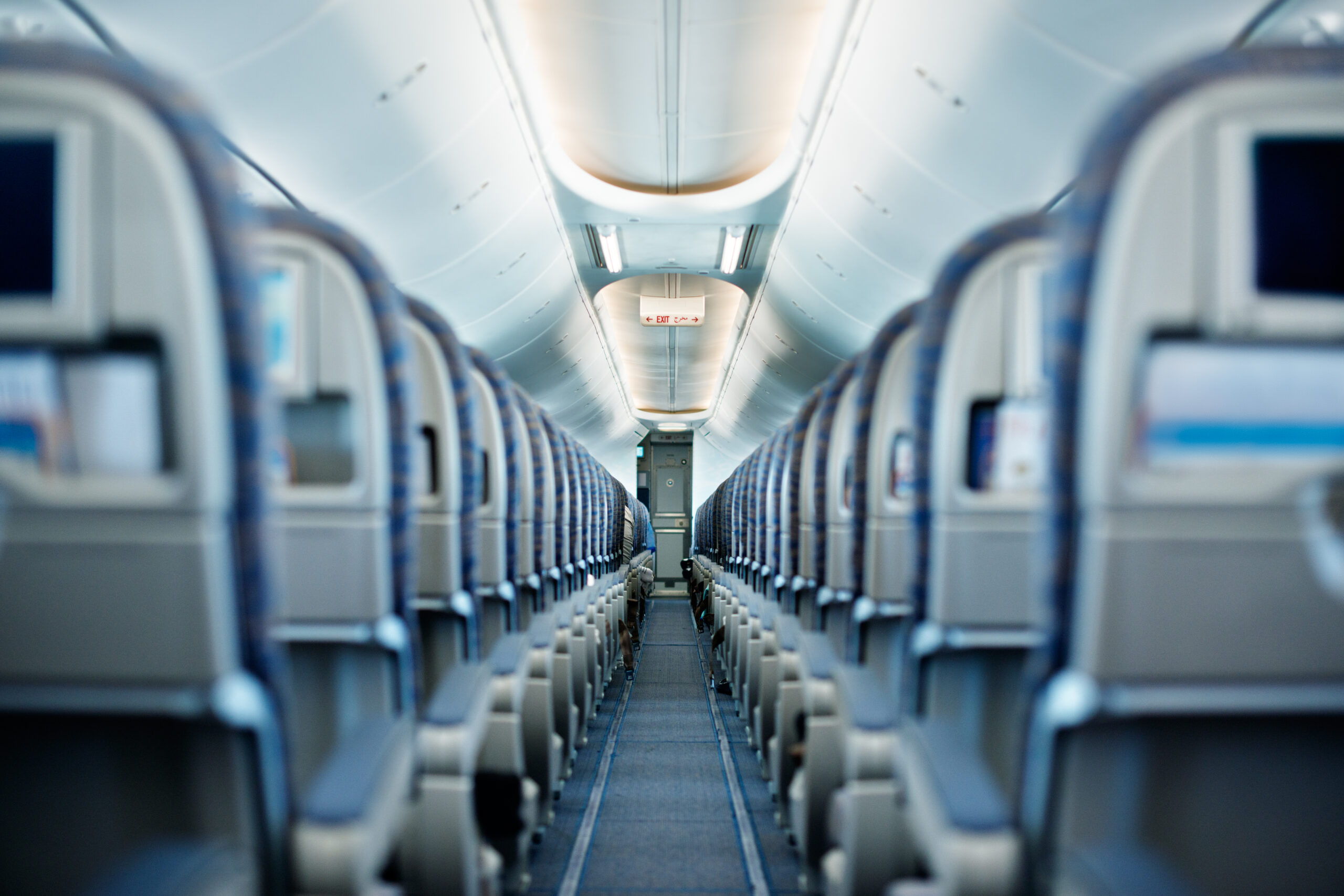 Row of empty airplane seats. Shallow DOF.